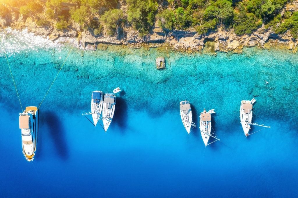 aerial-view-of-beautiful-yachts-boats-on-the-sea-bay-at-sunset